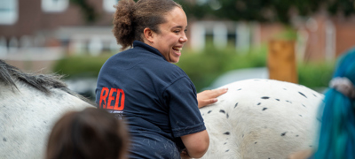 girl smiling near a white horse