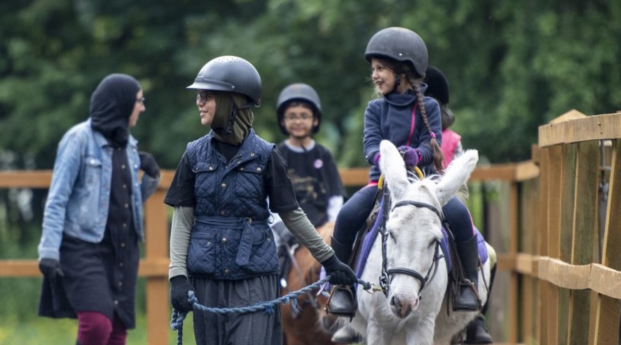 children riding on ponies