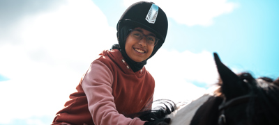Summerfield Stables 11.09.24 Close Up Young Girl Wearing Riding Hat During Riding Lesson (1)